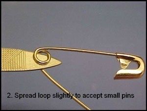 a pair of scissors that are next to each other with the words, 2 spread loop slightly to accept small pins