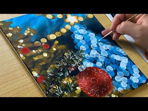 someone is painting on a piece of paper with buttons and paintbrushes in front of them