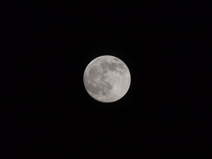 the full moon is seen in the dark sky with no clouds on it's side