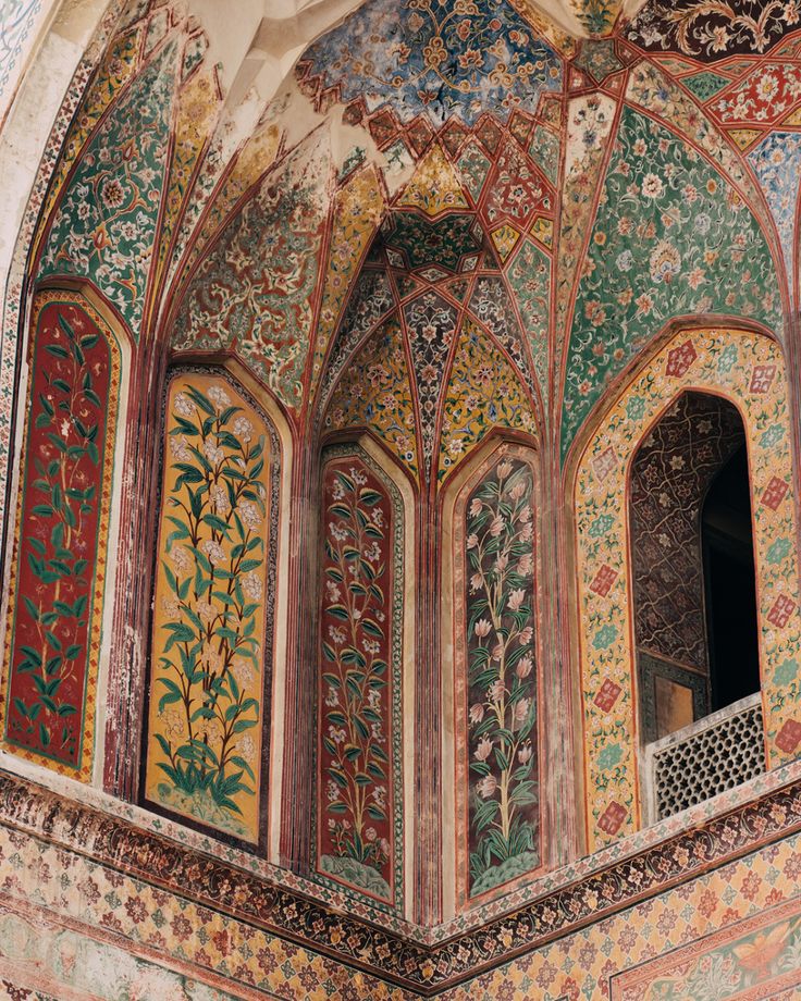 an intricately decorated building with many different colors and designs on the walls, including flowers