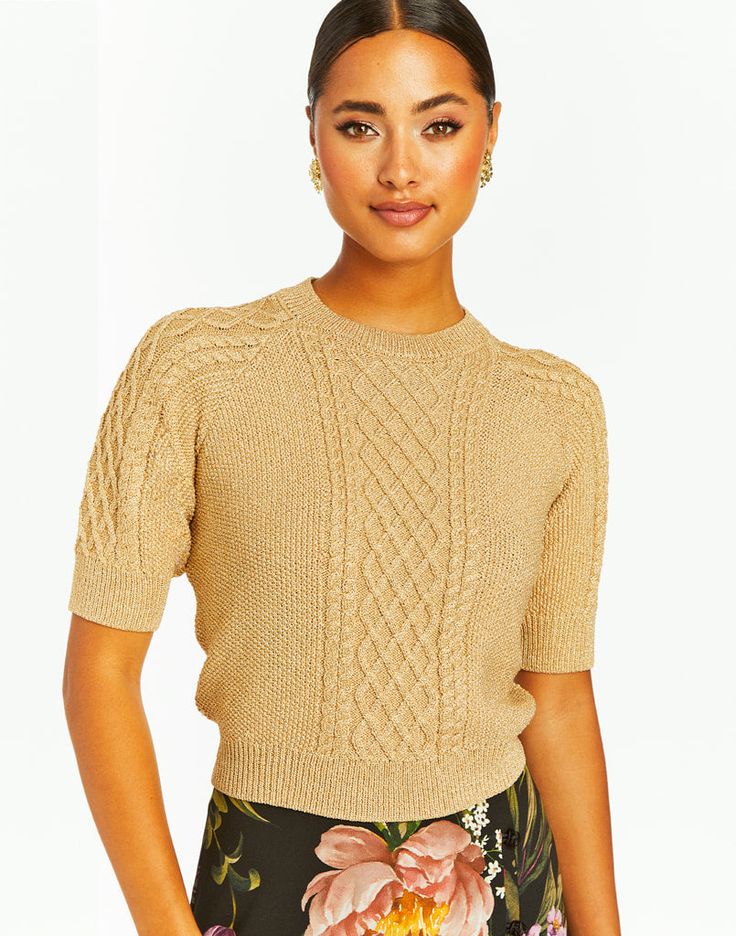 Cropped cable knit sweater with fitted crew neckline, short sleeves, and raglan shaping Metallic knit with lurex yarns 5% Metallic Lurex, 65% Polyester Wash instructions: Do not wash, Do not bleach, Do not tumble dry, Dry clean only, Iron low heat Model height is 5’9 | Sweater length from shoulder to hem is 17.5" Cropped Cable Knit Sweater, Metallic Knit, Cable Knit Sweater, Knitwear Women, Cropped Sweater, Model Height, Crew Neckline, Cable Knit, Knit Sweater