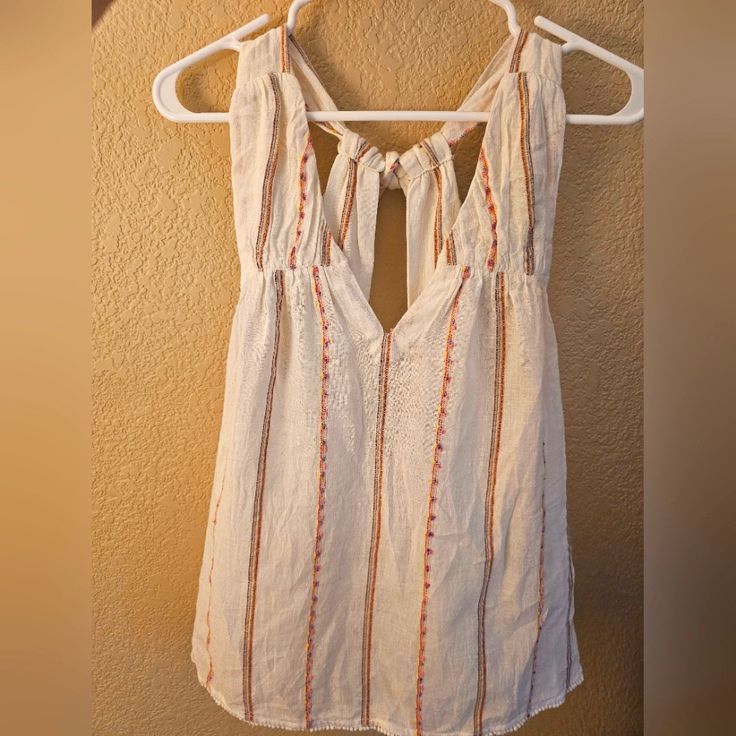 Brand New Anthropologie Flowy White Tank. Ties In Back, Colorful Threading Throughout. Size Small Petite, Fits Like Small Or Xsmall. New With Tags. Bohemian Tops With Tie Straps For Day Out, White Vacation Tops With Tie Straps, White Tops With Tie Straps For Vacation, White Tie Strap Tops For Beach, Cute V-neck Blouse For Beach, Cute White Beach Blouse, Bohemian Tie Back Top For Day Out, Bohemian Style Tie Back Top For Day Out, Cute Sleeveless Tie Back Tops