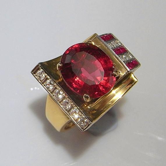 Here we have a superb late Art Deco circa 1940 vivid red rubellite tourmaline, ruby and diamond ring crafted in 14K yellow gold. Rings such as this custom made one of a kind ring from this period are extremely rare to see. True to the late part of the Deco era this ring is geometric, sculptural, chunky, luxurious and eye catching! The colors are divine vivid red, yellow gold, white. In total this ring weighs 11.69 grams. It is a size 5 1/2 US. Please enquire about sizing. The sculptural gem set Ruby Diamond Ring, Red Tourmaline, Art Deco Gold, Ring Ruby, Rubellite Tourmaline, Ruby Diamond Rings, Art Deco Engagement, Gold Art Deco, Ring Crafts