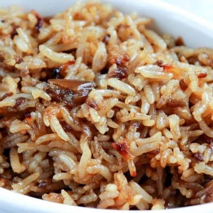 a white bowl filled with rice and meat