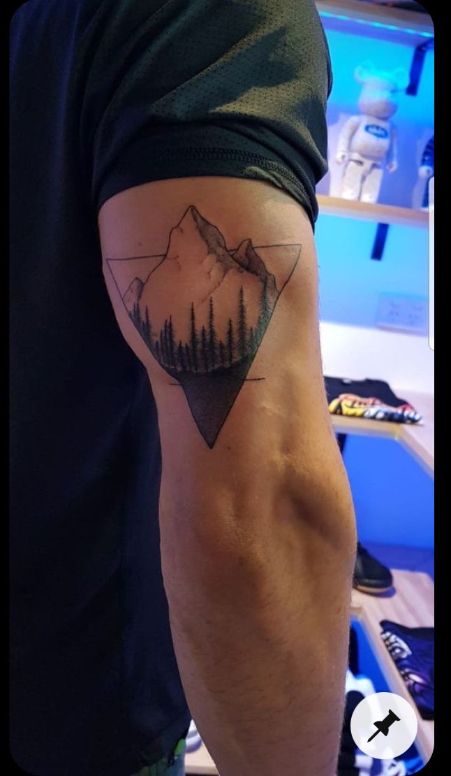 a man with a mountain tattoo on his arm