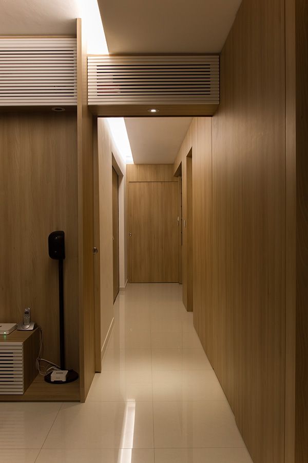 an empty hallway with wood paneling and white tile flooring is seen in this image