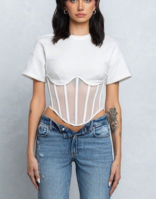 Elevate your tee game with the Eboni Mesh Bustier T-shirt, complete with unique mesh detailing and playful boning. This is no ordinary t-shirt - it's a statement piece for those who don't take themselves too seriously. PRE-ORDER - Mesh bustier boning detail terry short sleeve top - Short sleeve crewneck top - Full back zipper closure - French terry part has semi stretch - Mesh part has good stretch - Model size 5' 9" ( Wearing S size) Night Out Tops, Terry Shorts, Activewear Fashion, Mesh Sleeves, Bustier Top, Curve Dresses, Good Stretches, Club Dresses, Outerwear Jackets