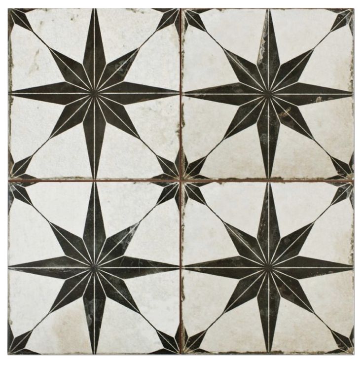 an old black and white tiled floor with star designs