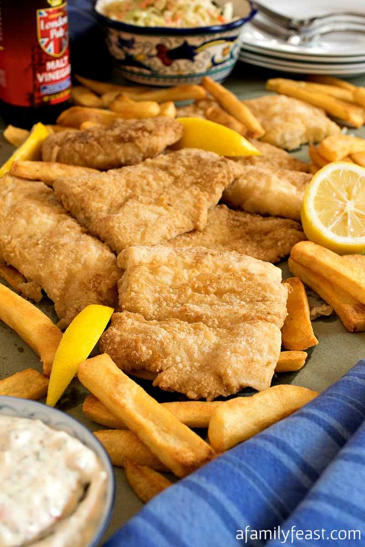 fried fish and french fries with lemon wedges