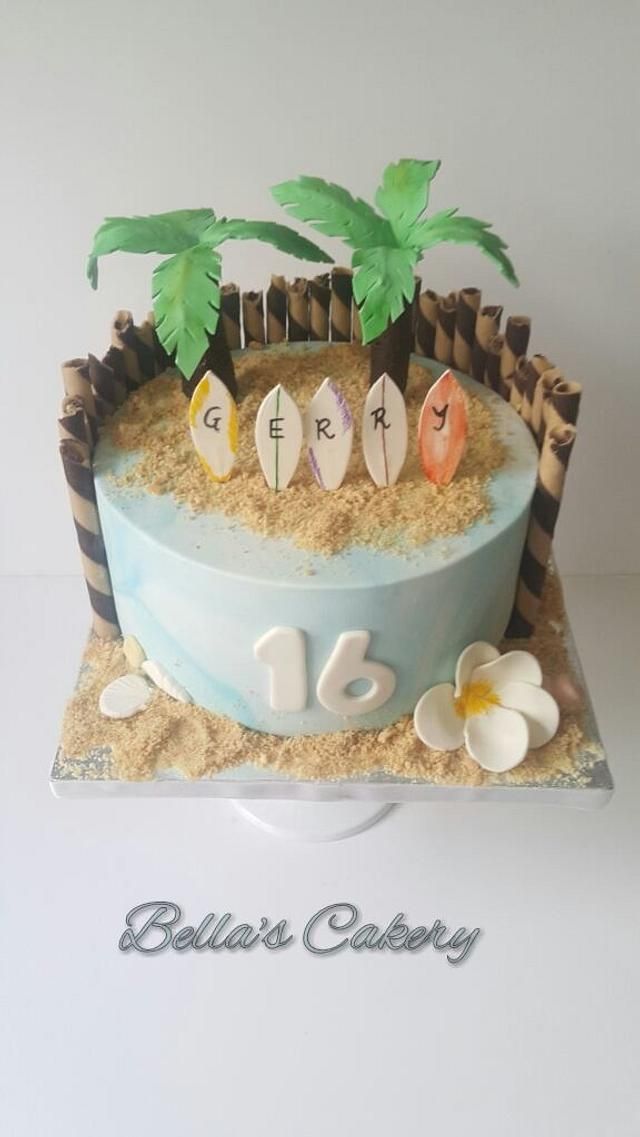 a birthday cake with the number sixteen on it and two palm trees in the sand