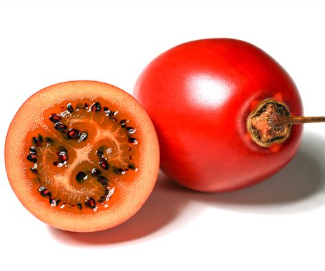 a whole and cut tomato on a white background