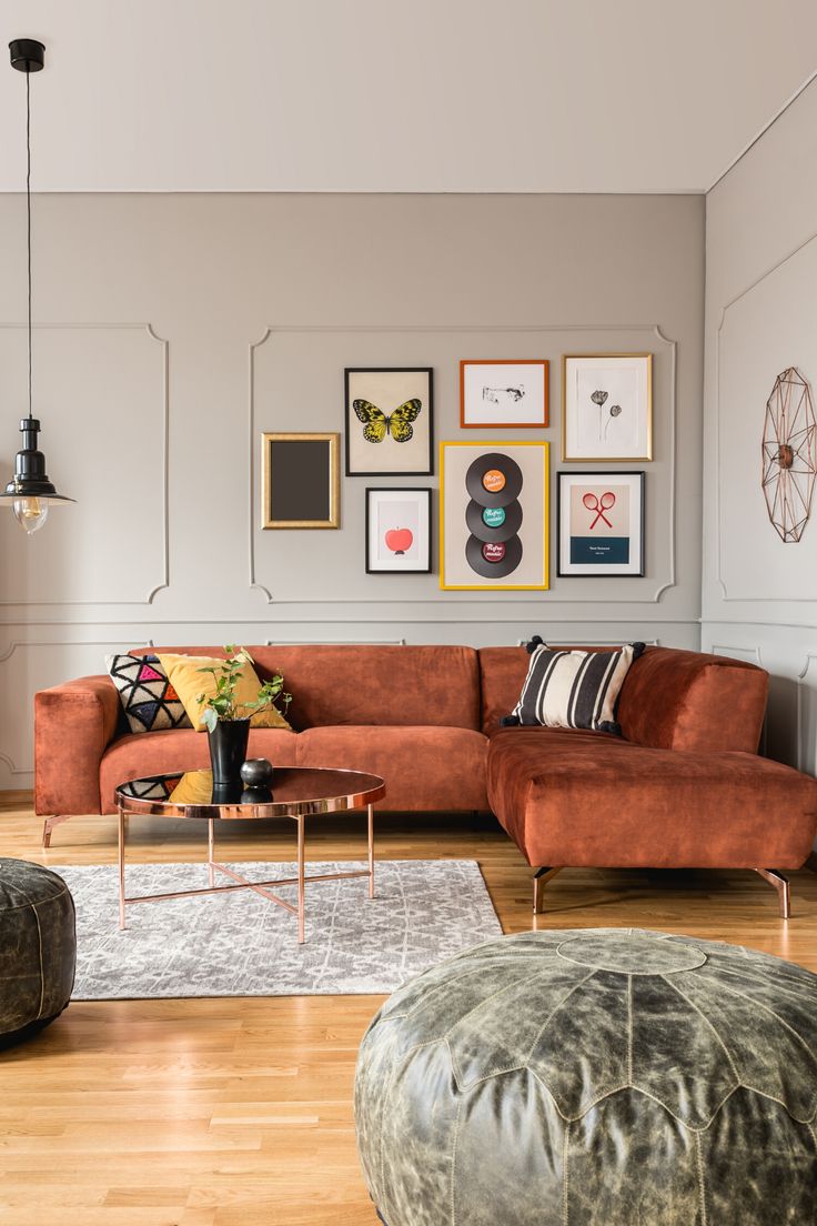 a living room filled with furniture and pictures on the wall