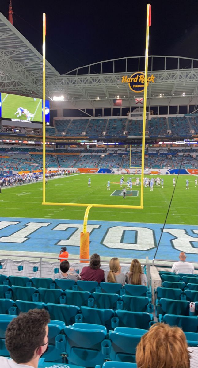 a stadium filled with people watching a football game