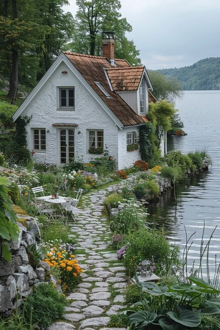 a white house sitting next to a body of water