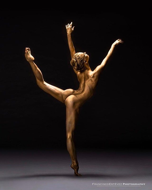 a nude woman is dancing in the dark