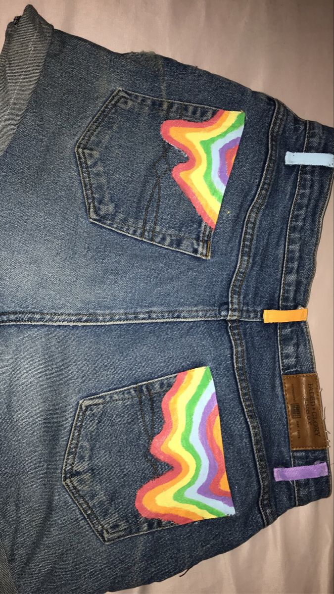 a pair of jeans with rainbow patches on them