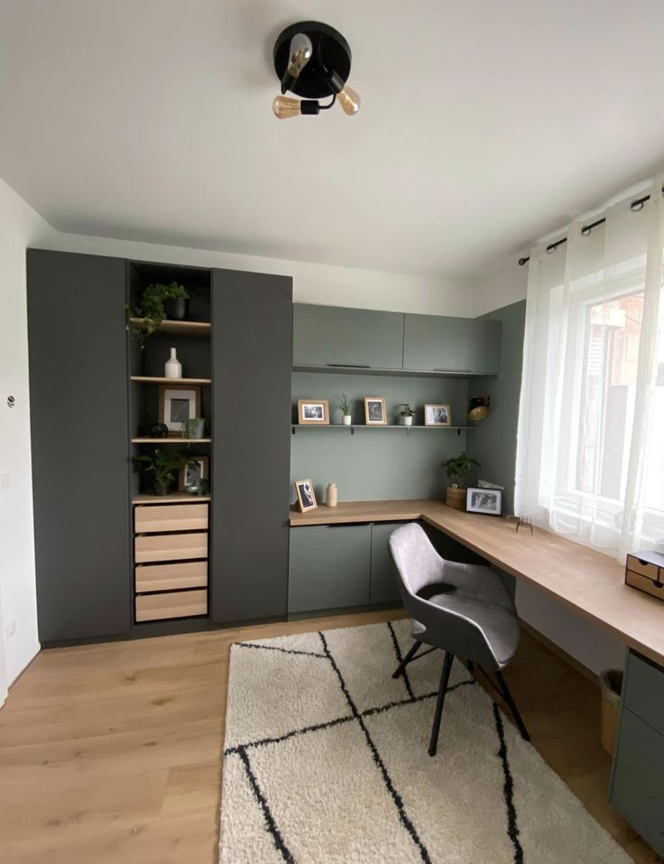 a home office with gray walls and wooden floors