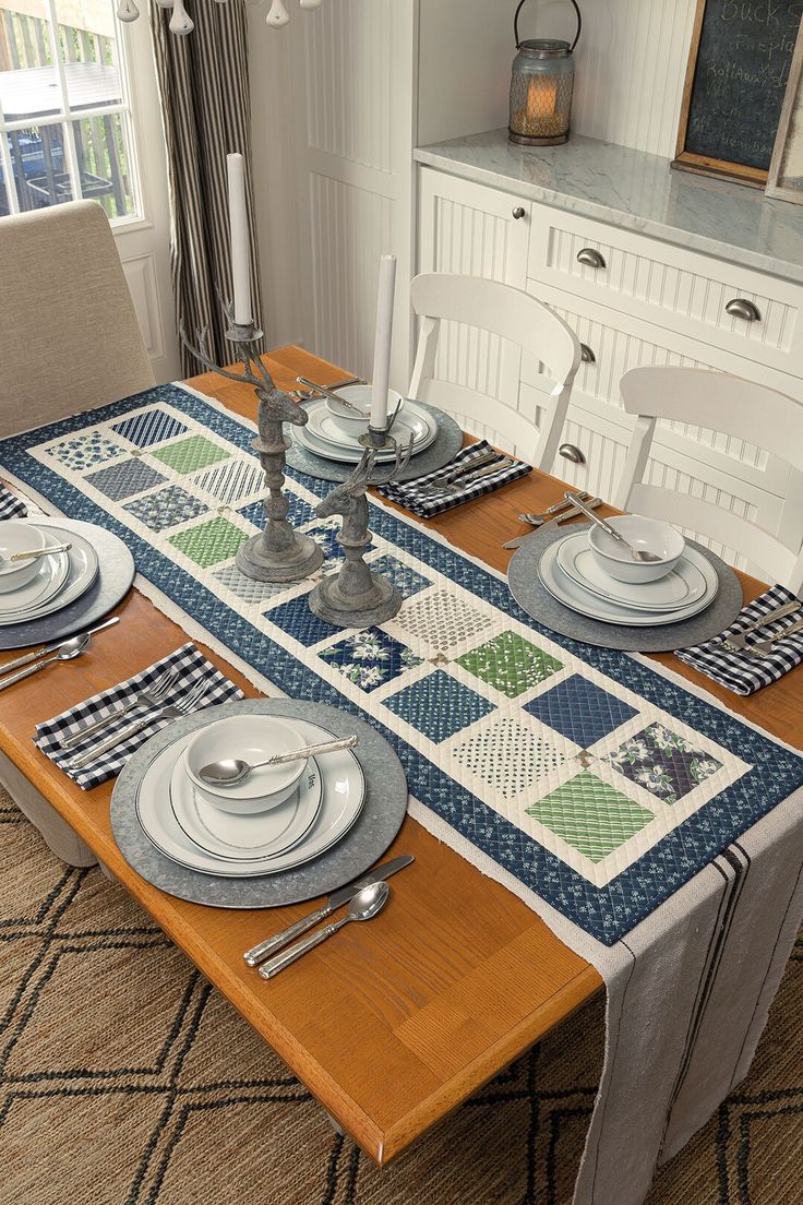 a dining room table with place mats and place settings on it, along with silverware