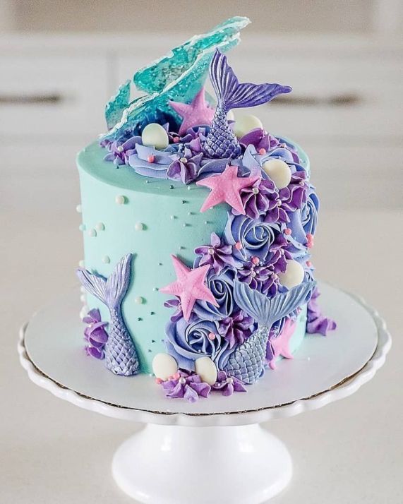 there is a cake decorated with purple and blue decorations