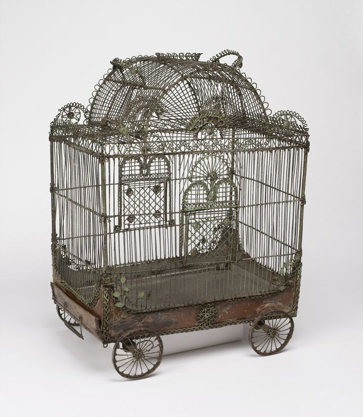 an antique bird cage with wheels and birds in it on a white background, there is no image here to provide a caption for