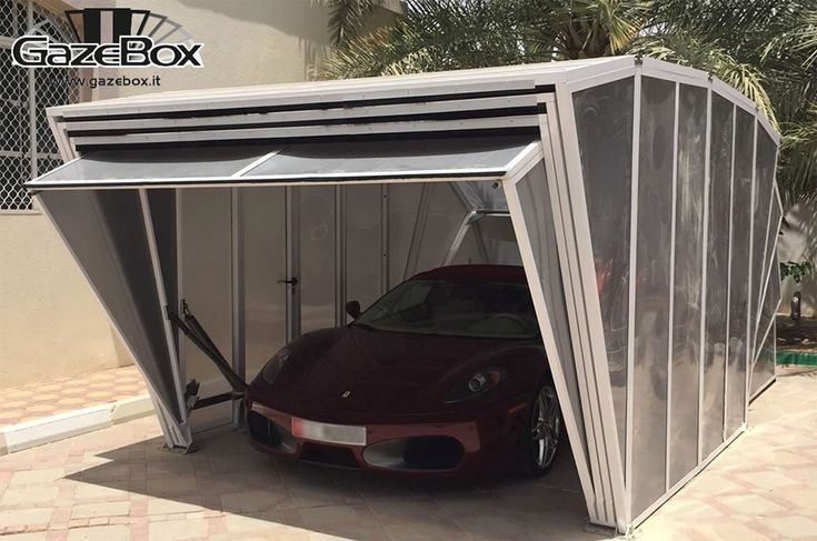 a car is parked in the garage with its door open