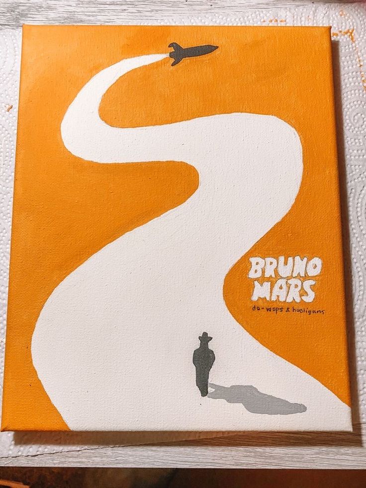 an orange and white book cover with a man standing in front of a winding road