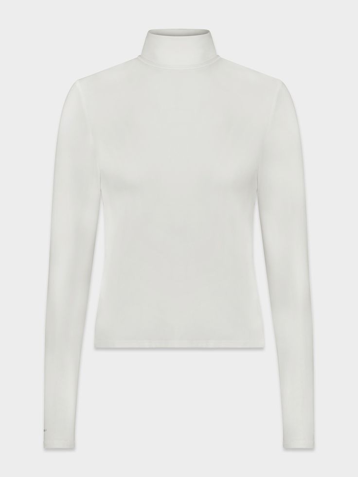 The Modal Turtleneck is the perfect winter layering piece. The beautiful shade of cream makes this the perfect addition to any outfit! White Stretch Turtleneck For Winter, White Funnel Neck Top For Layering, Classic White Fitted Long Sleeve Top, Winter White Long Sleeve Turtleneck, White Stretch Tops With Funnel Neck, Winter White Long Sleeve Top For Fall, White Stretch Winter Tops, Off White Tops For Layering In Fall, Off White Tops For Fall Layering