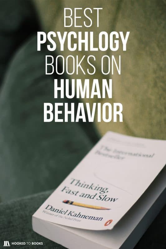 a book sitting on top of a couch next to a green chair with the title best psycllogy books on human behavior