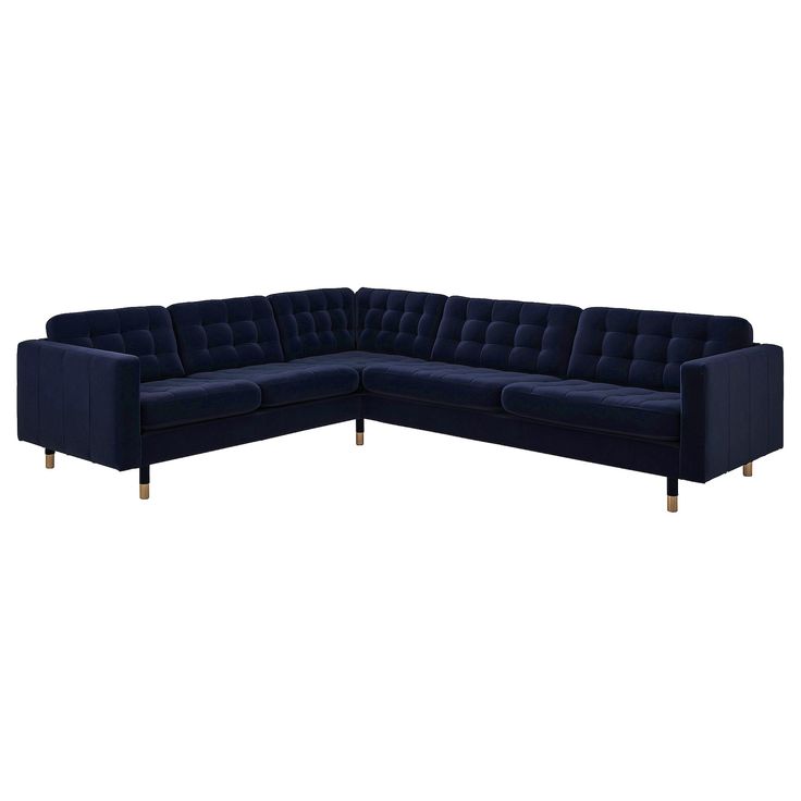 a blue sectional couch sitting on top of a white floor