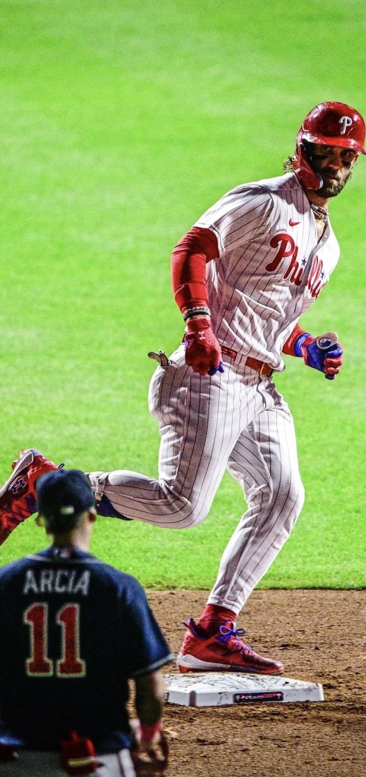 a baseball player is running to first base