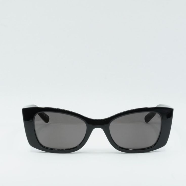 Step out in style with these Saint Laurent SL593 001 Black/Black sunglasses from OSSA FRAMES. Crafted from high-quality acetate, these designer frames are a must-have accessory for any fashionista. The sleek black frame and lens colors exude sophistication and elegance, making them a versatile choice for any outfit or occasion.  The cat-eye style of these sunglasses adds a touch of glamour and femininity to your look, while the 52mm lens width provides ample coverage and protection from the sun' Black Acetate Sunglasses With Gradient Lenses, Modern Black Acetate Sunglasses, Black Classic Acetate Cat Eye Sunglasses, Classic Black Acetate Cat Eye Sunglasses, Evening Acetate Sunglasses With Polarized Lenses, Evening Polarized Acetate Sunglasses, Evening Sunglasses With Tinted Acetate Lenses, Black Classic Cat Eye Sunglasses, Sleek Black Sunglasses With Glass Material