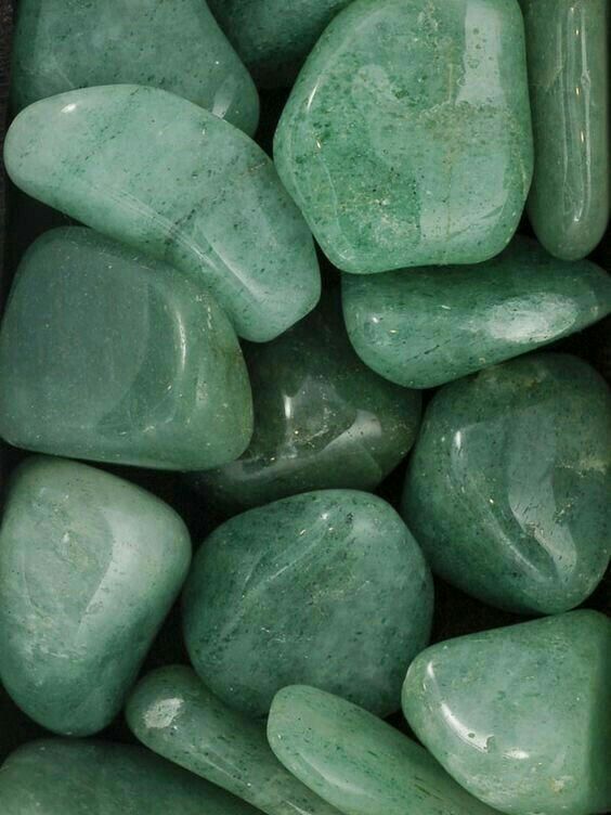 many green rocks are stacked together in a pile