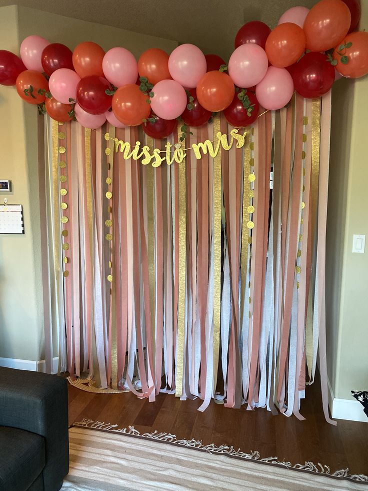 a room decorated with balloons and streamers