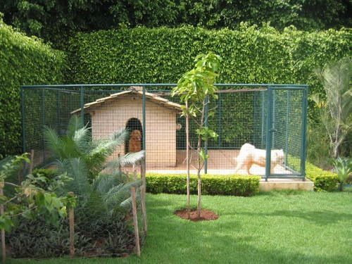 a dog house in the middle of a yard with trees and bushes around it,