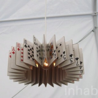 a light made out of playing cards hanging from the ceiling