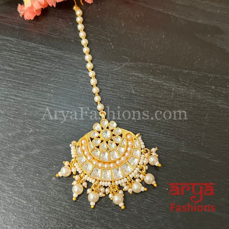 Bridal Rajwadi Kundan Mang Tika with Pearls Mang Tika: Approx. 5 Inches Hook feature to tie the mang tika to hair Made in Brass with golden finish and high quality Kundan stones Lightweight Jewelry Suitable for any occasion and traditional or Modern attire Ready to ship and available for local pickup from 23059. Please message us for more details Free shipping on orders above $75 within USA. Adjustable Gold Kundan Necklace With Latkans, Gold Tikka With Tilla As Gift, Gold Tikka For Navratri Gift, White Stone Work Tikka For Gifts, White Stone Work Tikka As Gift, Adjustable Tikka For Festive Occasions, Gold Tikka With Stone Work Gift, Gold Hand Set Tikka For Festivals, Hand-set Gold Tikka For Festivals