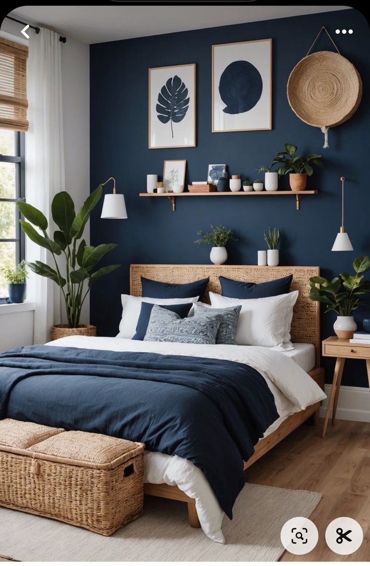 a bedroom with dark blue walls and white bedding, wicker baskets on the floor