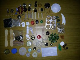 many different items are laid out on a wooden table with white dishes and spoons