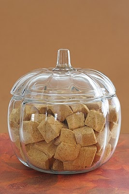 a glass bowl filled with dog food on top of a table