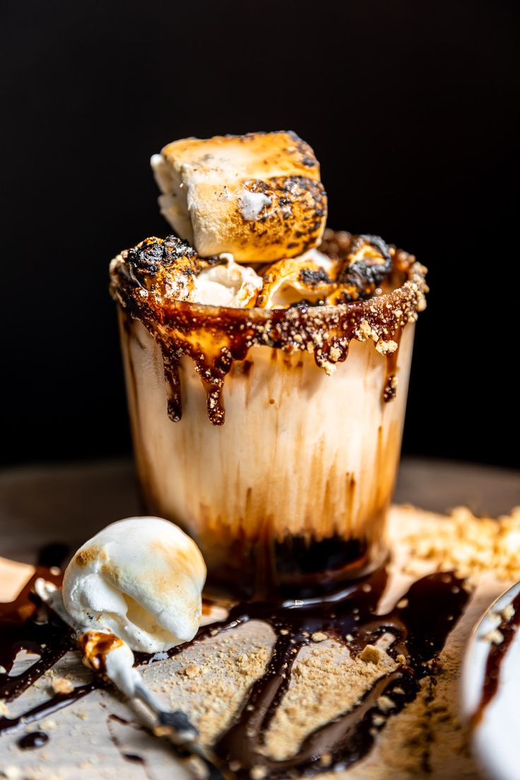 an ice cream sundae with chocolate sauce and marshmallows