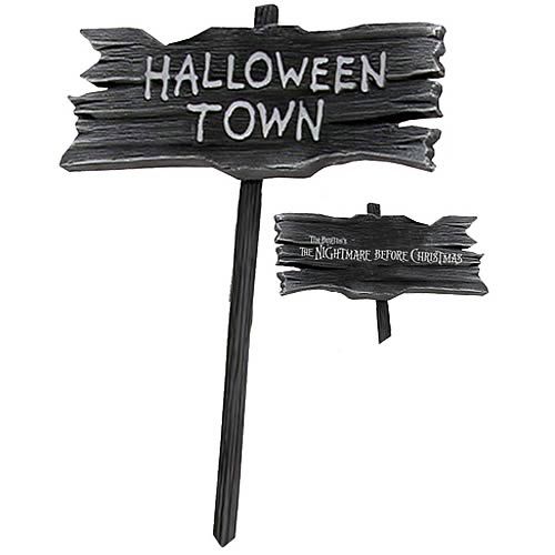 a wooden sign that says halloween town and has two arrows pointing in opposite directions to each other