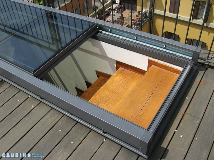 an open window on the side of a building with wooden flooring and railings