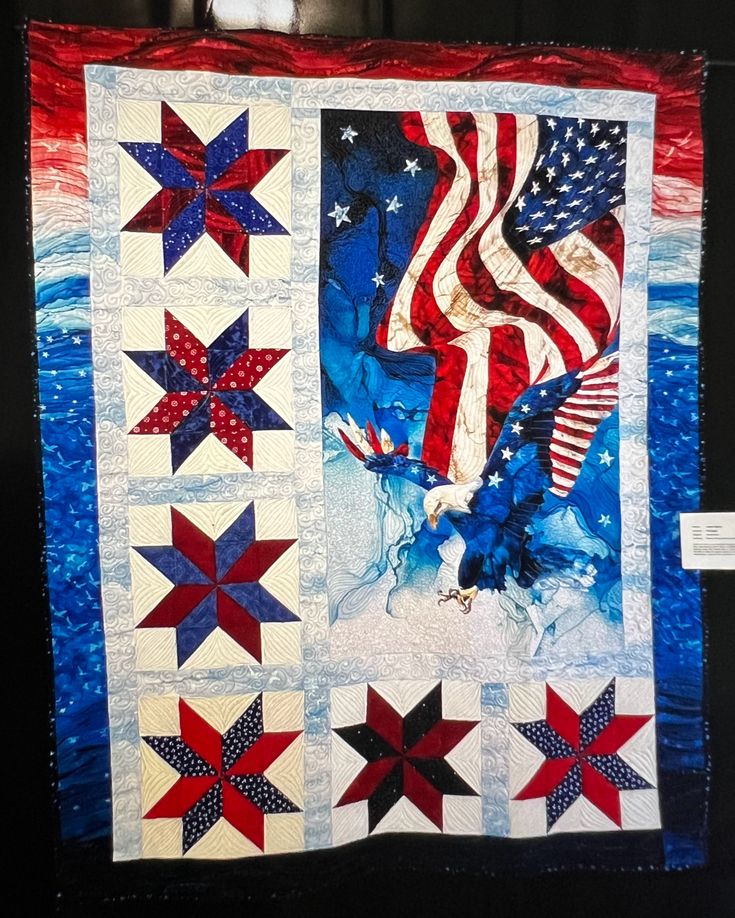 an american flag quilt hanging on the wall