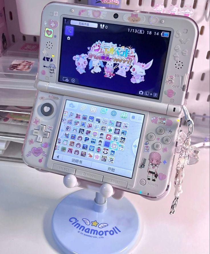 an electronic device is sitting on top of a stand with the screen showing cartoons and characters