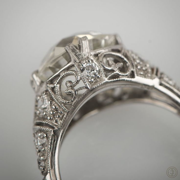 an antique style diamond ring with filigree accents