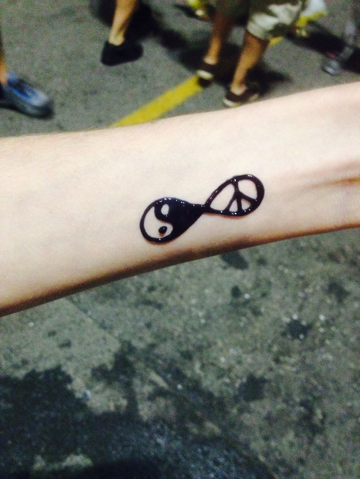 a person's arm with a tattoo on it that is shaped like an infinite sign