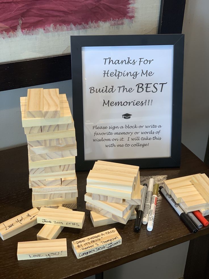 a wooden block with writing on it next to a framed sign that says thanks for helping me build the best memory