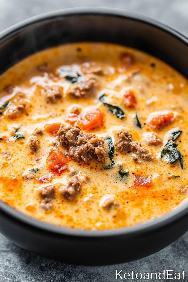 a close up of a bowl of soup on a table