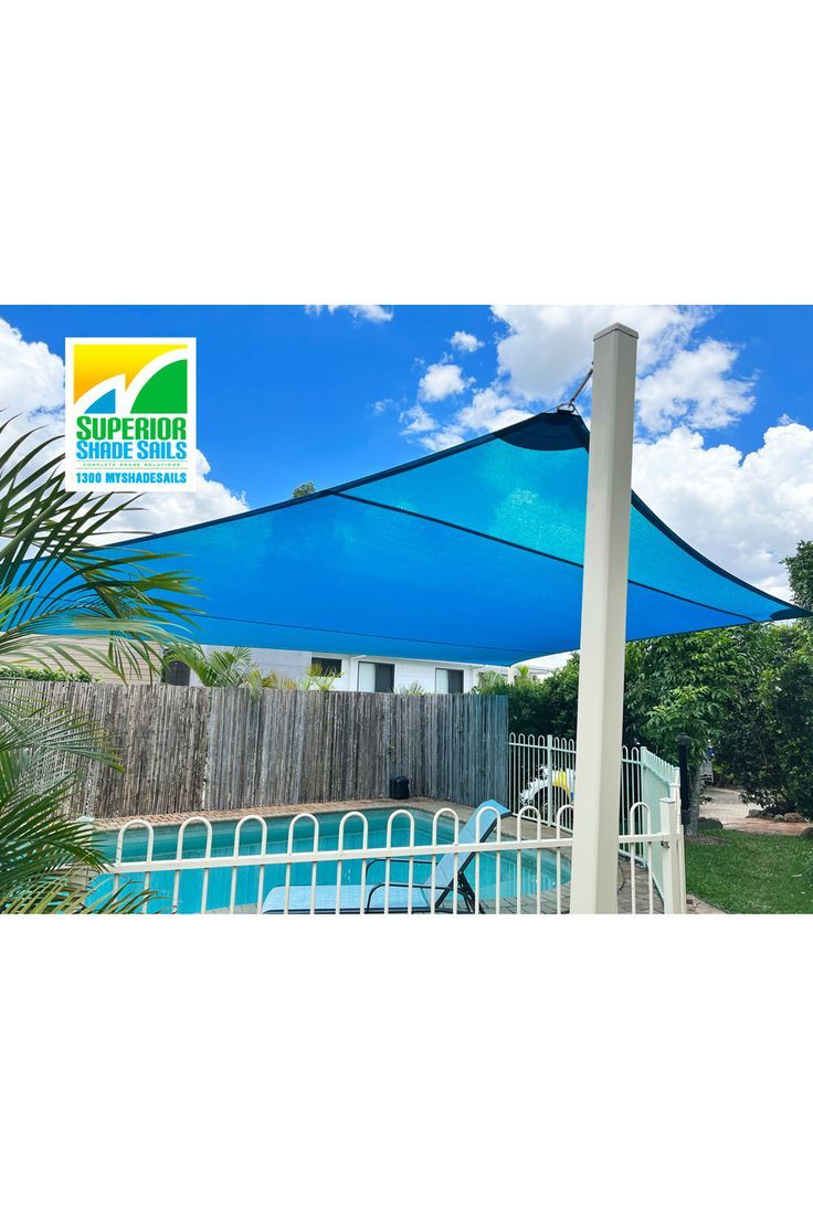 a blue umbrella sitting next to a swimming pool