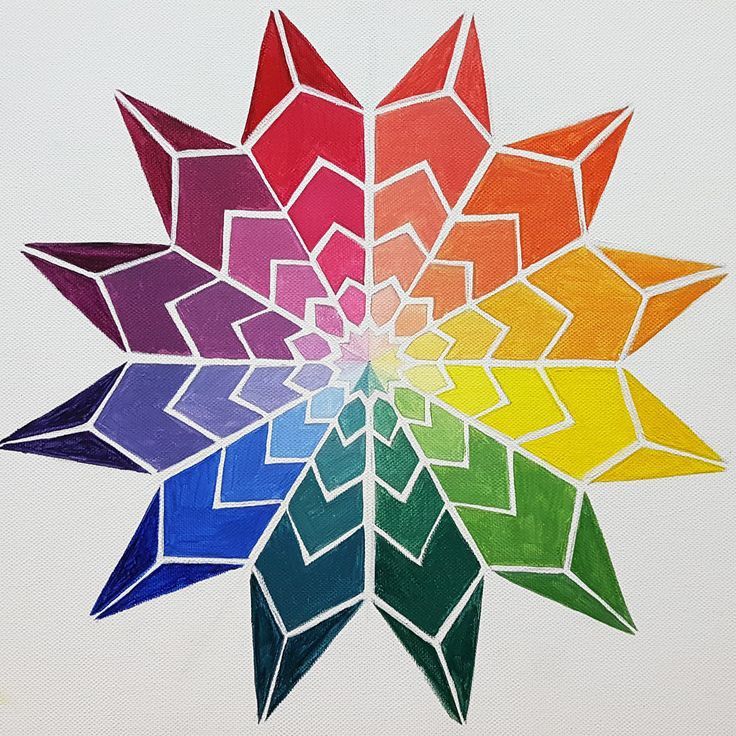 a multicolored snowflake on white paper